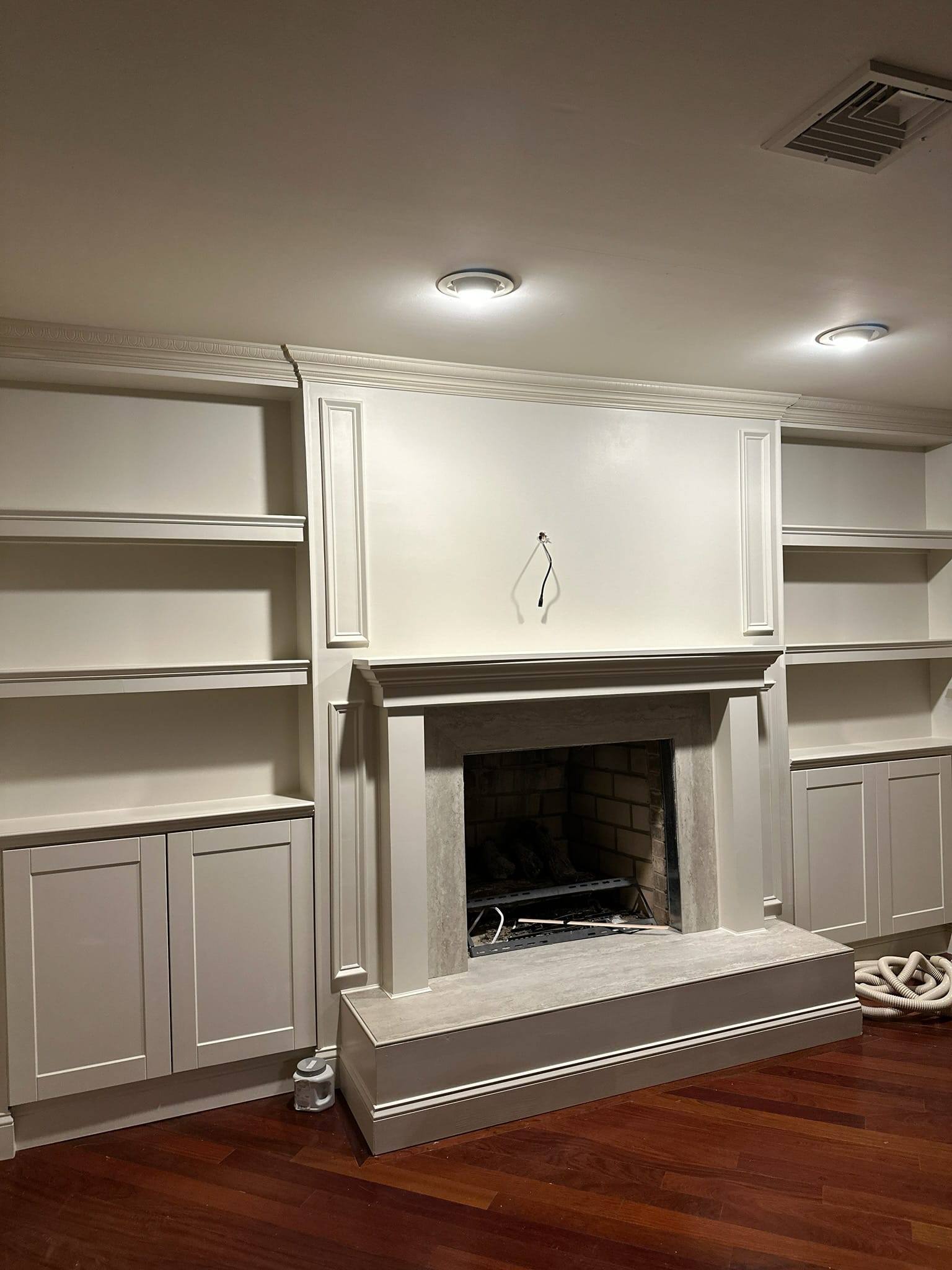 Fireplace after renovation — custom built-ins with stone surround