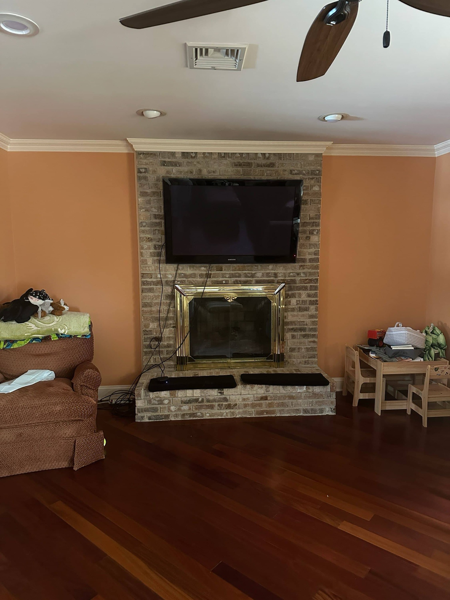 Fireplace before renovation — brick with brass insert